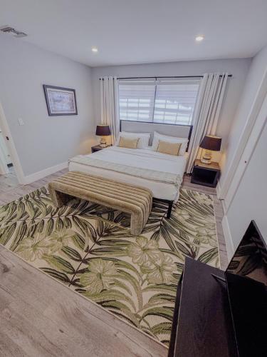 a bedroom with two beds and a large window at Zoka House 5 mints from Brickell in Miami