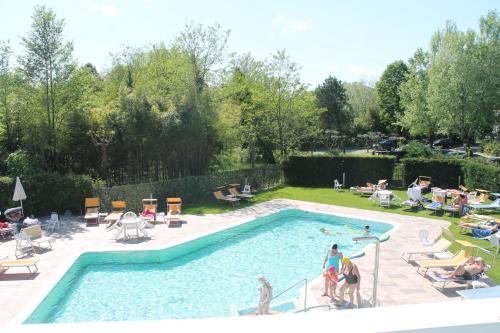 a group of people standing around a swimming pool at Terme Villa Pace in Abano Terme