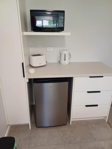 a white desk with a microwave on top of it at Rotorua Studio in Rotorua