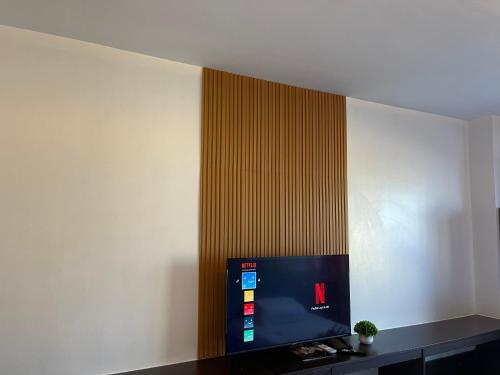 a room with a wall with a tv on it at Premiere Haven MOA Staycation in Manila