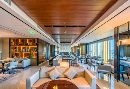 a lobby of a hotel with couches and chairs at Hyatt Regency Shanghai Global Harbor in Shanghai