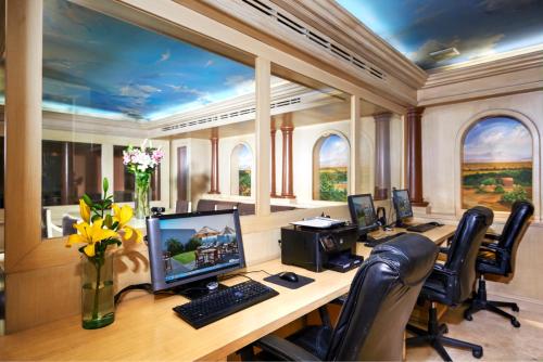 an office with a desk with a computer and chairs at Hotel Royal Reforma in Mexico City