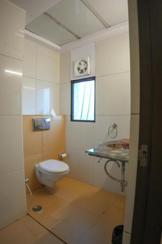 a bathroom with a toilet and a sink at The Shanti A Boutique Hotel in Jodhpur