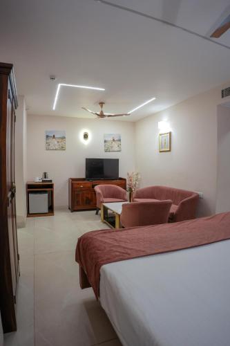 a hotel room with a bed and a living room at The Shanti A Boutique Hotel in Jodhpur