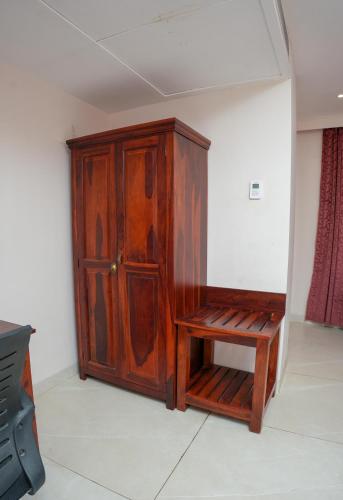 a wooden cabinet with a bench in a room at The Shanti A Boutique Hotel in Jodhpur