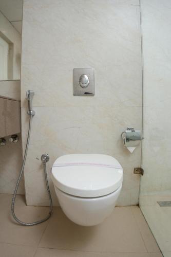 a white toilet in a bathroom with a shower at The Shanti A Boutique Hotel in Jodhpur