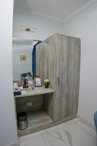 a wooden door in a room with a desk at The Shanti A Boutique Hotel in Jodhpur