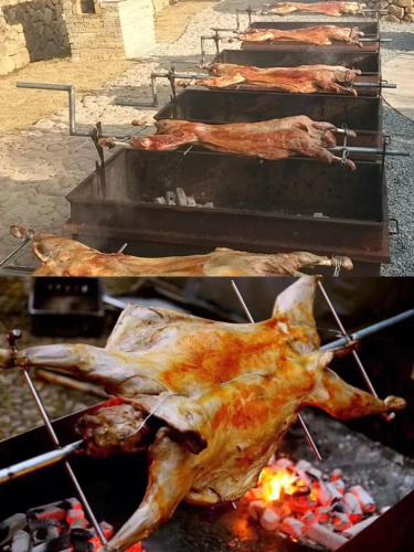 a group of chickens cooking on a grill at The Western Clouds in Deqing