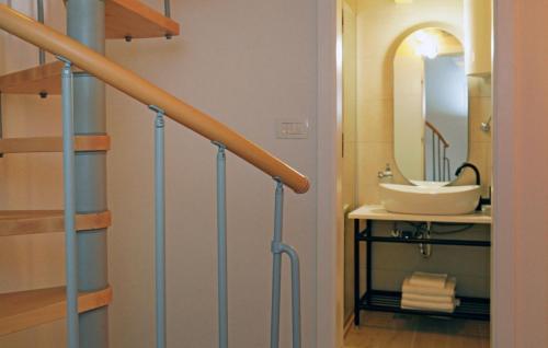a bathroom with a sink and a staircase with a mirror at Villa Urska in Bol