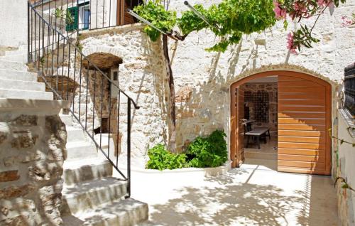 an entrance to a building with a wooden door and stairs at Villa Urska in Bol