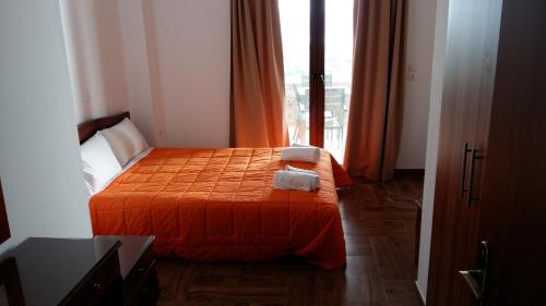 a bedroom with a bed with two towels on it at Villa Molivos Castle in Mithymna