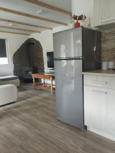 a kitchen with a stainless steel refrigerator in a room at Vagabundo Home in Rogačica