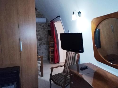 a living room with a chair and a television at Holiday Residence in Casamassima