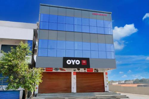 an office building with an ovs sign on it at Hotel O Nayati Grand in Hyderabad