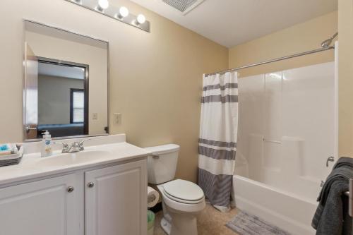 a bathroom with a sink and a toilet and a shower at Spacious and Modern Stay to Relax & Recharge in Mansfield