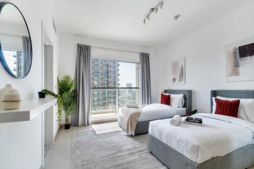 a hotel room with two beds and a mirror at Stella Stays Lana Tower in Dubai