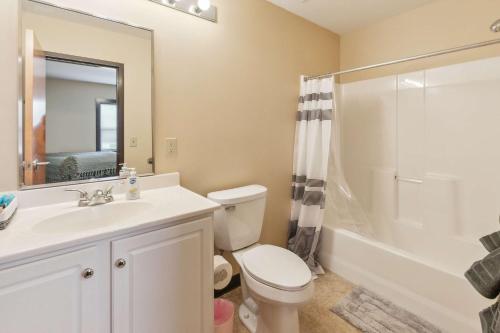 a bathroom with a toilet and a sink and a shower at Work Relax Repeat in a Bright and Spacious Stay in Mansfield