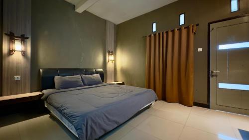 a bedroom with a bed and a window and a door at Sky View Bromo Guest House in Ngadisari