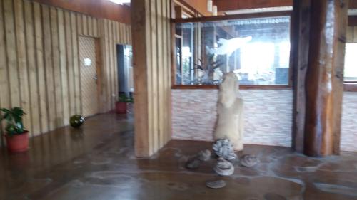 a statue of a person in a room at Tupa Hotel in Hanga Roa