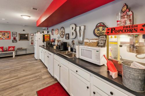 a fast food kitchen with a counter with a sink and refrigerator at Bright and Connected Your Ideal Getaway in Mansfield