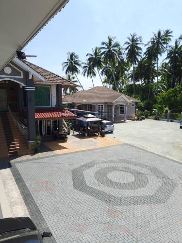 a building with a mosaic design on a driveway at Airport Riverside Roomstay & Homestay in Kota Bharu
