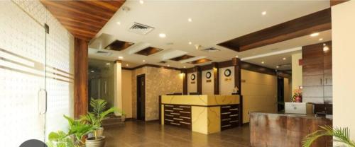 a lobby with a reception desk in a building at SK Premium Park GGN in Gurgaon