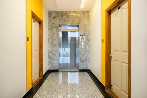 a hallway with two doors and a tile floor at Treebo Breeze Way, Rushikonda in Visakhapatnam