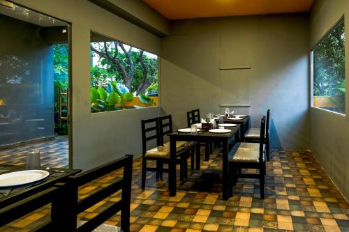 a dining room with a long table and chairs at Treebo Breeze Way, Rushikonda in Visakhapatnam