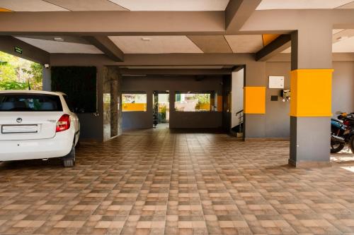 a white car parked in a parking lot at Treebo Breeze Way, Rushikonda in Visakhapatnam