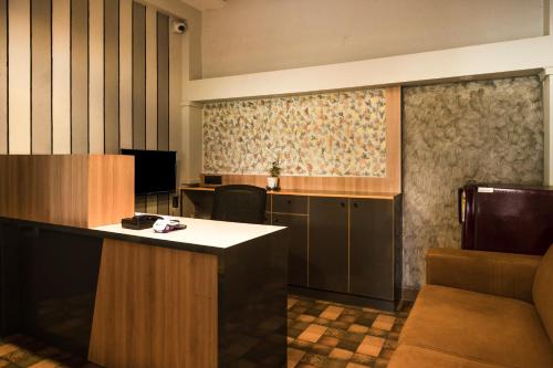 a hotel room with a reception desk and a room at Treebo Breeze Way, Rushikonda in Visakhapatnam