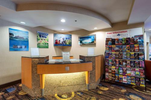 a store lobby with a desk in a store at Howard Johnson Plaza by Wyndham by the Falls Niagara Falls in Niagara Falls