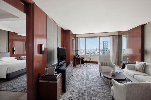a hotel room with a bed and a television at Shanghai Marriott Marquis City Centre in Shanghai
