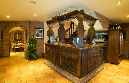 an old wooden counter with vases on it in a room at Hotel Boutique El Pescador in Cudillero