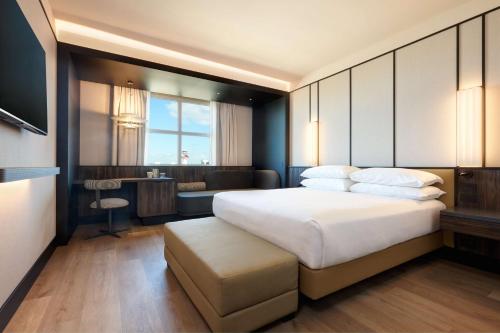 a bedroom with a large bed and a desk at Hilton Rome Airport in Fiumicino