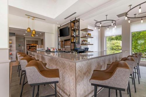 a bar with a row of chairs sitting around it at Hilton Garden Inn Portland Airport in Portland