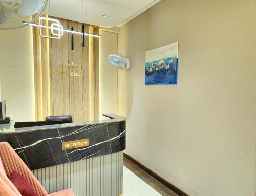 a hair salon with a reception desk in a room at Krishna Residency A Boutique Hotel in Bareilly