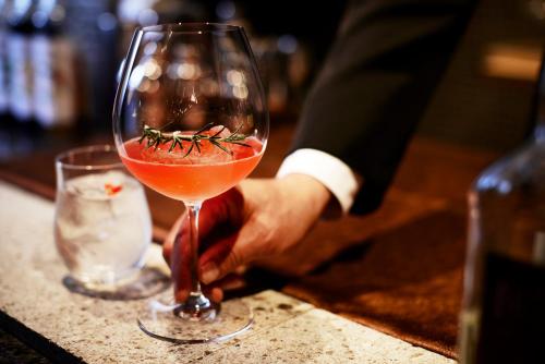 a person holding a wine glass with a tomato on it at Keio Plaza Hotel Tokyo Premier Grand in Tokyo