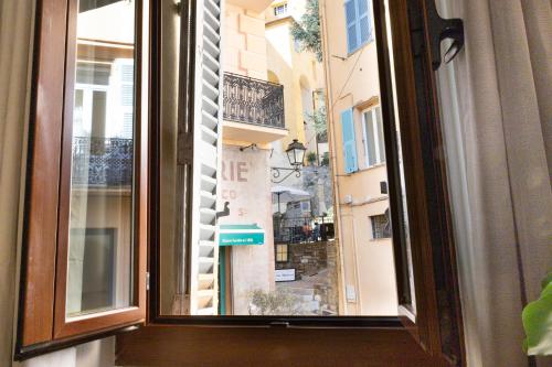 a window with a view of a city at Les Logettes 2 in Menton
