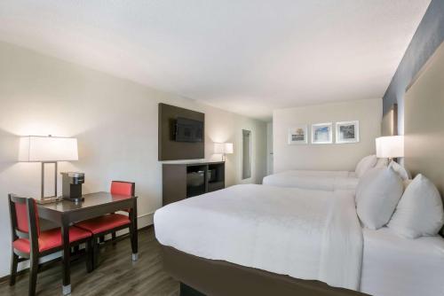 a hotel room with a bed and a desk at Clarion Hotel Conference Center in Maggie Valley