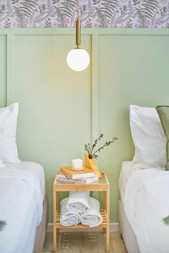 a bed room with two twin beds and a table at Modern Studio Empire Damansara, Near 1 Utama & IKEA in Petaling Jaya