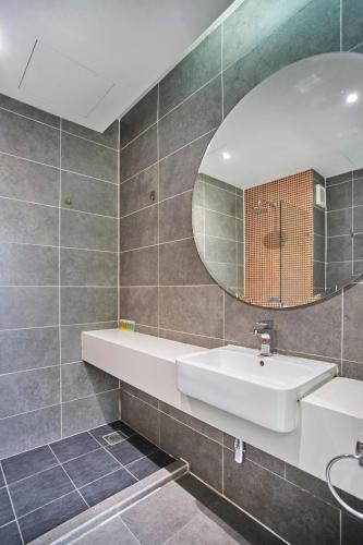 a bathroom with a sink and a mirror at Modern Studio Empire Damansara, Near 1 Utama & IKEA in Petaling Jaya