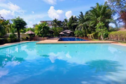 a large swimming pool with blue water at Le Oasis - 3BR Beachfront HOME in Laguna & Layan Beach next KORA Resort in Phuket