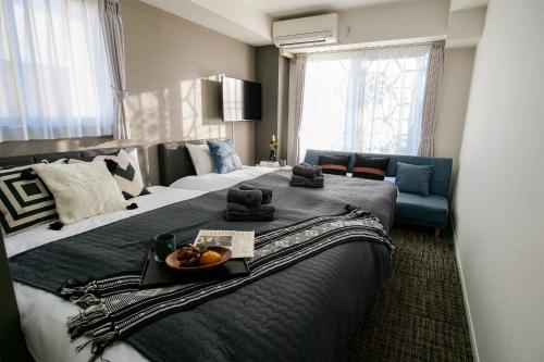 a hotel room with a large bed with a bowl of fruit on it at Mr Kintaro Higashikomagata in Tokyo