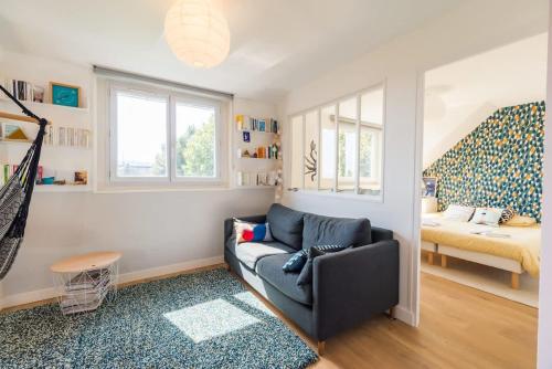 a living room with a couch and a bed at BiNiC ' ATTiC - Vue Mer - Centre Binic - Renove in Binic-Etables-sur-Mer