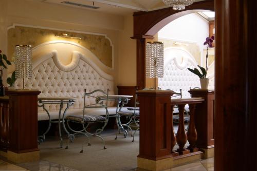 a restaurant with a table and chairs in a room at Hotel Il Principe in Milazzo