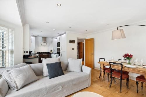 a white living room with a couch and a table at Free parking - Villa Apartment - Hosted by StaySejour in Brighton & Hove