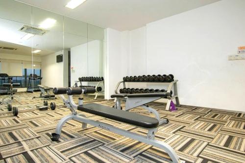a gym with two exercise bikes and a mirror at Royal Strand Country Garden Danga Bay in Johor Bahru