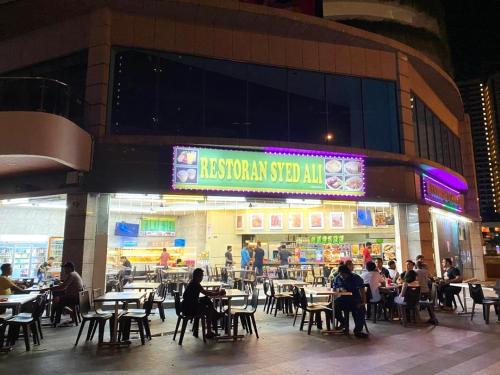 a restaurant with tables and people sitting at tables at Royal Strand Country Garden Danga Bay in Johor Bahru