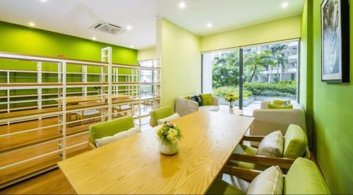 a dining room with a wooden table and chairs at Royal Strand Country Garden Danga Bay in Johor Bahru