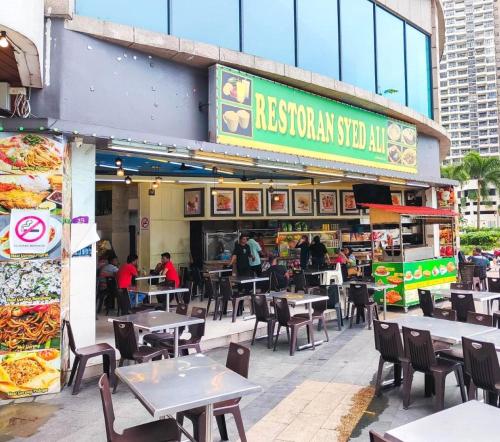 a restaurant with tables and chairs in front of it at Royal Strand Country Garden Danga Bay in Johor Bahru